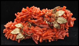 A vintage Frank Hess / Miriam Haskell spezzati coral coil bracelet having gold tone filigree and