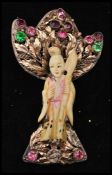 A 1940s Hobé Asian Lady brooch pin featuring a carved faux ivory Asian lady, wearing a tinted robe