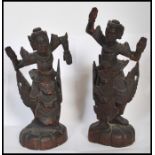 A pair of early 20th century Chinese / Asiatic wooden hand carved figurines of Buddhas / deities