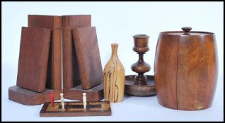 A collection of wooden treen items to include a lead lined barrel shaped caddy, a turned wooden