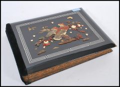 An early 20th Century Japanese lacquered wood photograph / postcard album, the silk pages painted