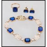 A fantastic 14ct gold Hong Kong Demi-Parure bracelet, earrings and ring set having blue faceted