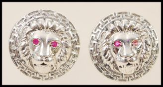 A pair of stamped sterling silver designer style cufflinks with embossed lion heads and greek key