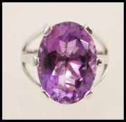 A stamped 925 silver ring prong set with a large oval amythest stone. Weight approx 9.1g. Size Q.