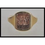 A hallmarked 9ct gold signet ring having a rectangular head with a turnable centre one side