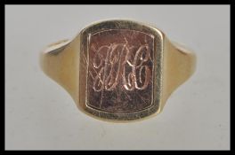 A hallmarked 9ct gold signet ring having a rectangular head with a turnable centre one side