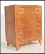 A 1930's Art Deco oak chest of drawers by Lebus. Raised on angled tapering legs with a central