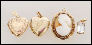 A selection of 9ct gold pendants to include a two hallmarked heart shaped lockets, a cameo pendant