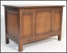 A 20th century oak Jacobean revival blanket box, panel sides with squared legs and hinged top above.