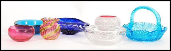 A selection of 20th Century coloured studio glass to include a triangular shaped blue glass bowl