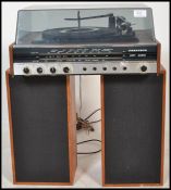 A retro 1970's Ferguson Hi-fi stereo in teak with smoked acrylic hood being complete with the