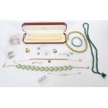 A group of silver and costume jewellery to include rings, green rhinestone floral necklace, boxed