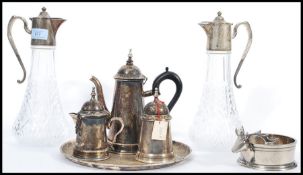 A group of good quality silver plate to include a pair of silver plated and cut glass claret jug,