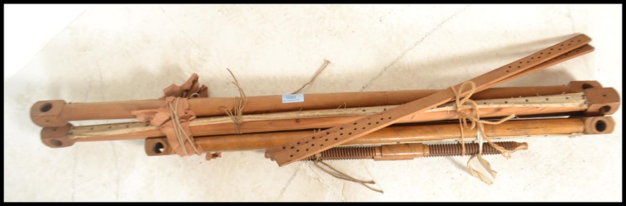 An unusual 20th century tapestry / fabric loom. The batons with pommel heads and strings etc for