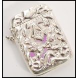 A stamped sterling silver vesta case with embossed masonic decoration featuring a G surrounded by