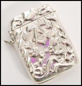 A stamped sterling silver vesta case with embossed masonic decoration featuring a G surrounded by