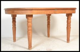 A vintage 20th century large teak wood dining table by Rainforest furniture raised on turned legs