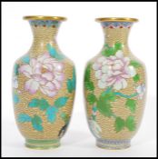 A pair of 20th Century vases Chinese Cloisonne vases decorated with peonies and birds on a yellow