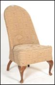 A mid 20th Century Victorian revival walnut spoonback nursing chair, with floral carved rail, button