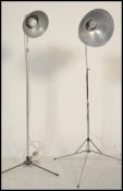 Two vintage retro 20th century telescopic adjustable photographic lamps raised on brushed steel