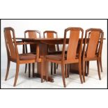 A 1970's retro teak wood dining room suite comprising a set of 6 dining chairs and an extending