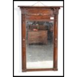 A late Victorian mahogany pier mirror, having decorative turned columns flanking the rectangular