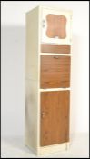 A mid century retro vintage two tone upright kitchen pedestal cabinet. The white body with faux wood