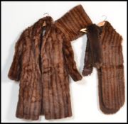 A set of vintage furs comprising of fur coat with matching stole and scarf. Makers label to