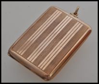 A stamped 375 9ct gold vesta case of square form having striped engraved decoration and loop to