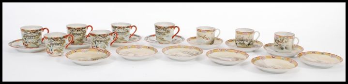 A group of nine 19th century Japanese eggshell china tea cups and saucers being hand painted with