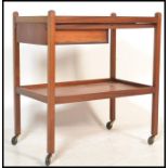 A vintage mid 20th Century teak wood two tiered buffet / drinks trolley, single drawer fitted to the