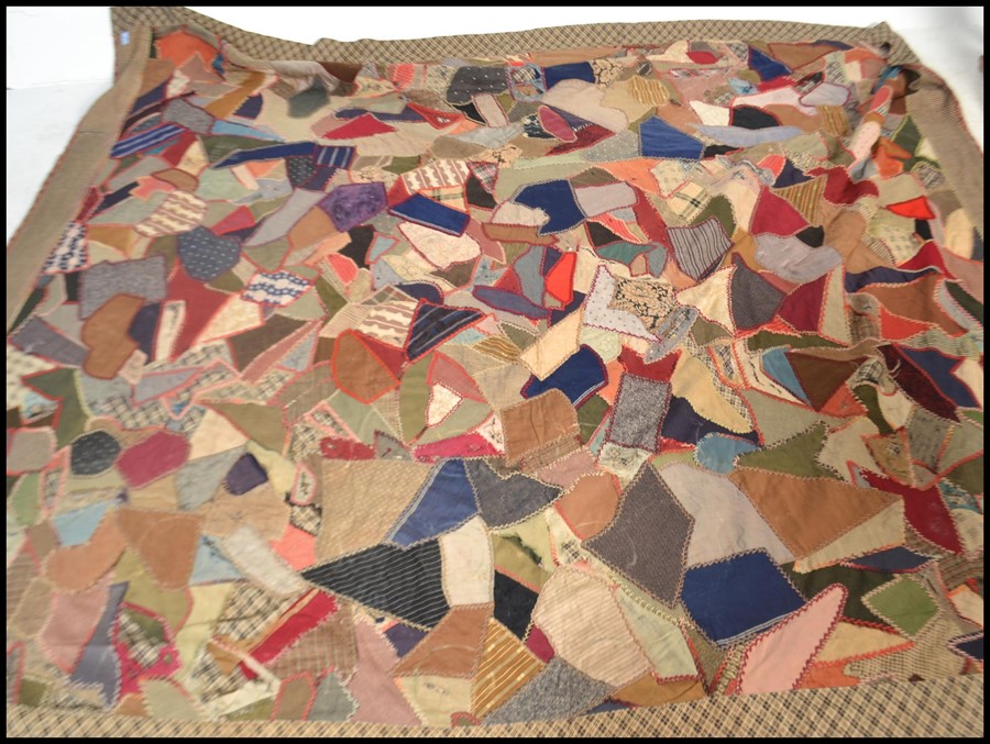 A vintage early 20th century patchwork throw / blanket / bed cover, constructed from various