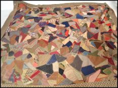 A vintage early 20th century patchwork throw / blanket / bed cover, constructed from various