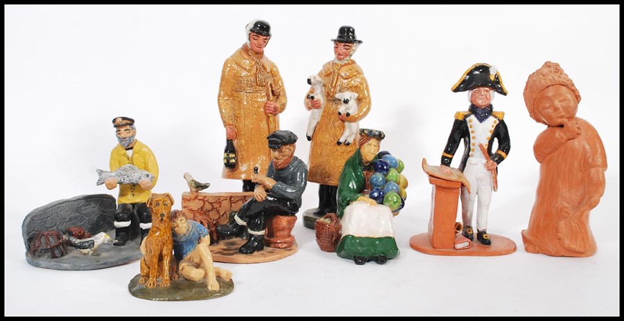 A collection of naive clay pottery figurines being hand painted and glazed in the manner of Royal