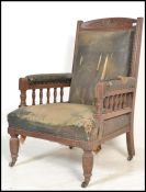 An 19th Century Victorian mahogany library armchair. The chair raised on turned legs with spindle
