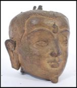 A 19th century Chinese bronze Buddha head having detailed features. 15cm high.