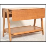 A mid 20th century retro teak two tier  buffet trolley / side table raised of angular form, being