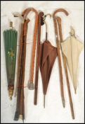 A collection of vintage walking sticks canes from the 20th Century together with a stunning silk