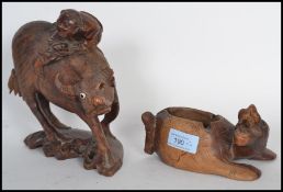 Two early 20th century carved Chinese wooden figurines to include an ox on plinth base with man