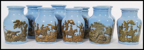 A group of nine 19th century Victorian prattware paste bottles having light blue ground with hunting