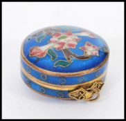 A 19th century Chinese cloisonne pill pot box on pendant bale hoop. Deep blue ground with decoration