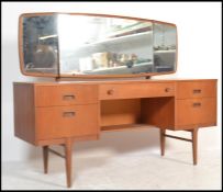 A retro 20th Century kneehole twin pedestal teak wood dressing table, triptych mirror to the top