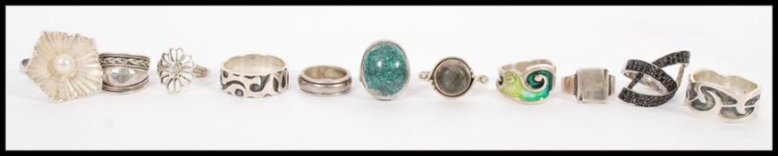 A selection of silver rings to include a green agate and silver ring, a celtic platted design