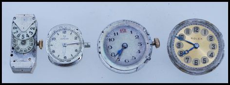 Two early 20th Century Rolex movements for ladies round wrist watches and a similar small omega