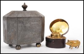 A 19th Century travelling hinged top inkwell cased with a red leather lining, a stunning brass pig