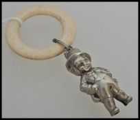 A 19th Century Victorian silver plate childs rattle in the form of a boy in a top hat and tails