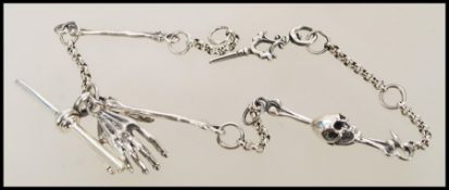 A silver albert watch chain with skeleton details. Weight 21.7g.