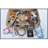A good selection of costume jewellery to include and amber coloured bead necklace, a cloisonne