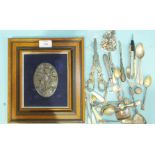 A Continental oval white metal plaque depicting a cherub amongst grapes and vines, stamped EK 830,