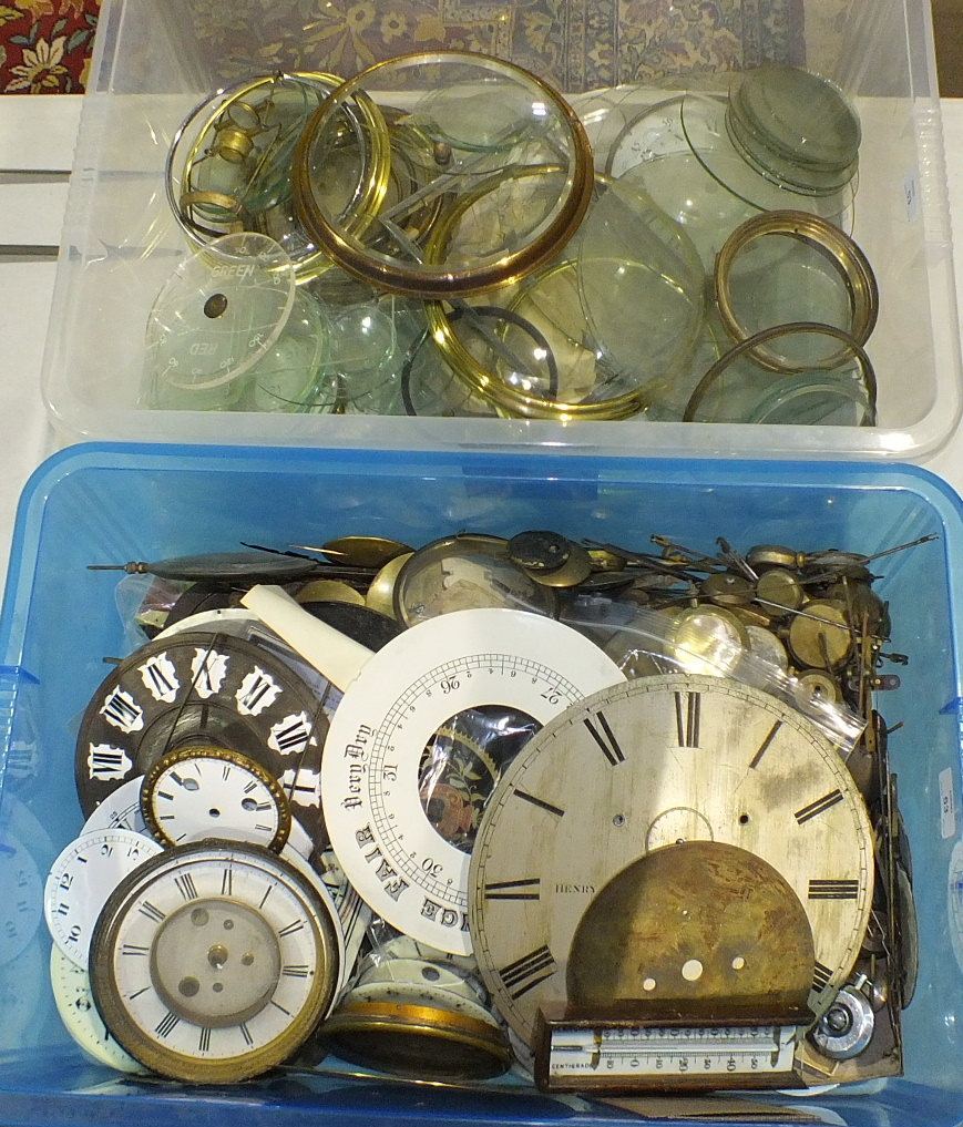 A collection of clock pendulums, clock dials, bezels, etc.